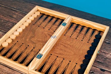 Long backgammon are placed on the board against the background.