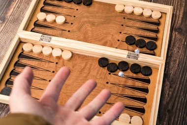 The boy threw two dice onto the backgammon board.