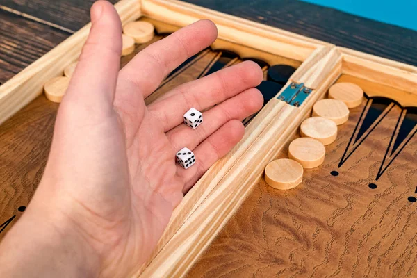 Boy Throws Two Dice Backgammon Board — Stockfoto
