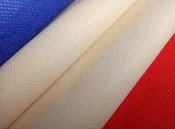 beige, blue, red non-woven polypropylene fabric with corrugated roll