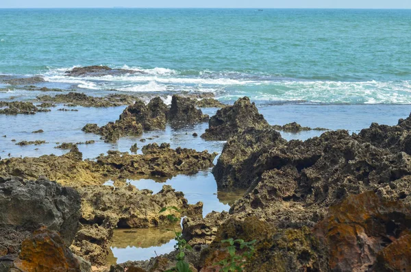 rocks on the coast. hard lumps of earth against a blue sea background. marine tourism spots on manuk island, Banten, Indonesia