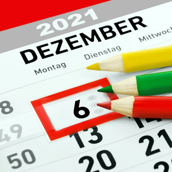 3 pencils red green yellow and German calendar 2021 December 6  and weekdays