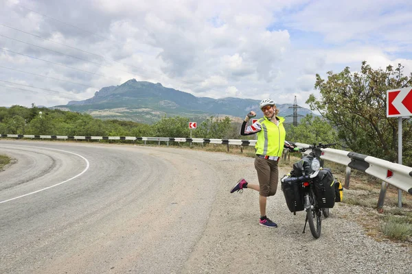 Happy Woman Bike Traveler Stands Loaded Bike Highway Mountains — Stock fotografie