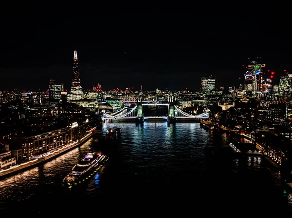 London Tower Bridge at Night with urban architectures Aerial drone view. One of Londons most famous bridges and must-see landmarks in United Kingdom — стокове фото