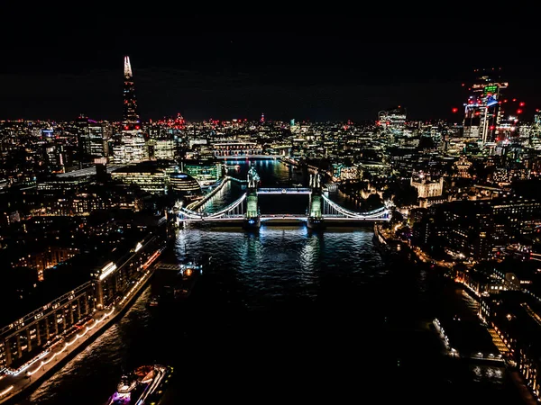 London Tower Bridge at Night with urban architectures Aerial drone view. One of Londons most famous bridges and must-see landmarks in United Kingdom — Stockfoto