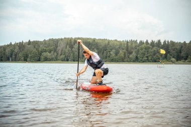 Vaidava, Latvia - 01.08.2021: SUP stand up paddle boarding. SUP competition, race. awesome active outdoor recreation. 