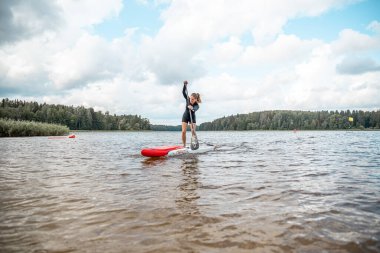 Vaidava, Latvia - 01.08.2021: SUP stand up paddle boarding. SUP competition, race. awesome active outdoor recreation. 