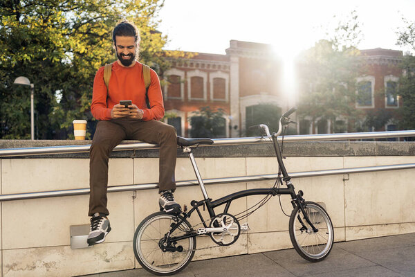 Man Smiling and Using Phone