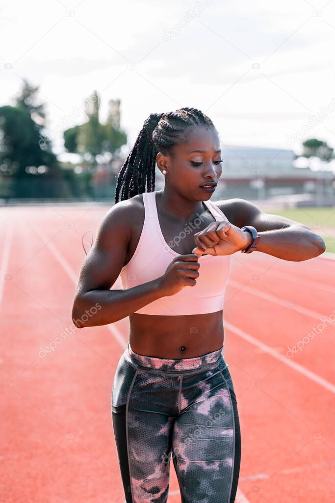 Athlete sprinter watching the clock while running