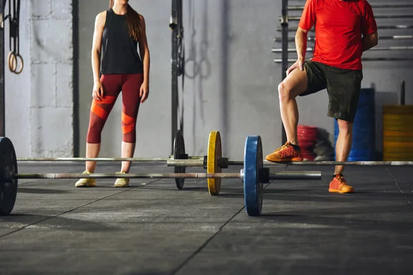 People standing in front of barbells. — Foto de Stock