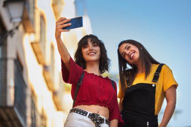 Two teenager girls taking a selfie.
