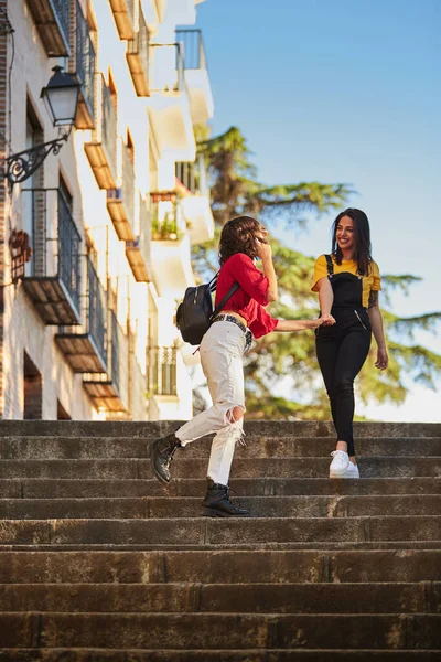 Two teenager girls walking down stairs. — стоковое фото
