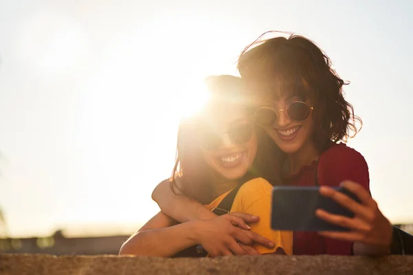 Two teenager girls taking a selfie. — Photo
