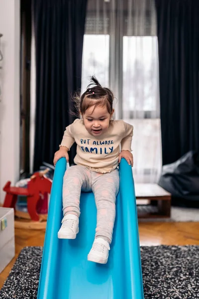 Stock Photo Cute Girl Having Fun Home Using Little Slide — Stock Photo, Image