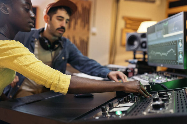 Stock photo of cool artists working in professional music studio.