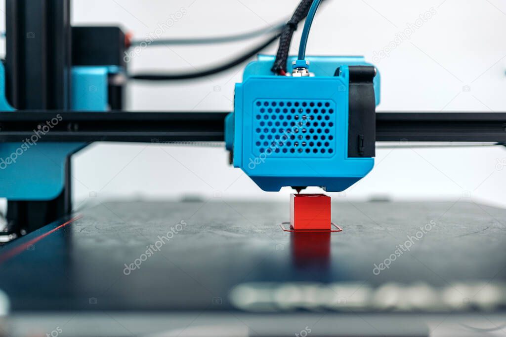 Stock photo of modern 3d printer printing cool red design.
