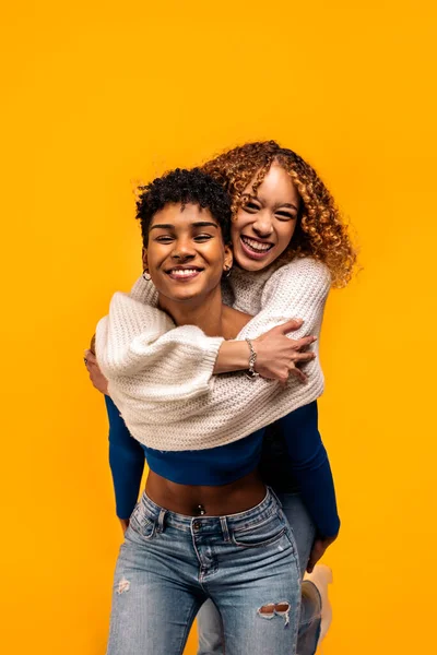 Stock Photo Cheerful Afro Women Hugging Each Other Studio Shot — Φωτογραφία Αρχείου