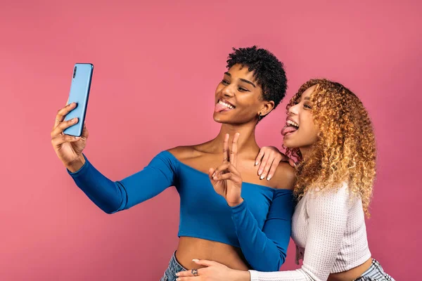 Stock Photo Cheerful Afro Women Posing While Taking Selfie Studio — Stock Fotó