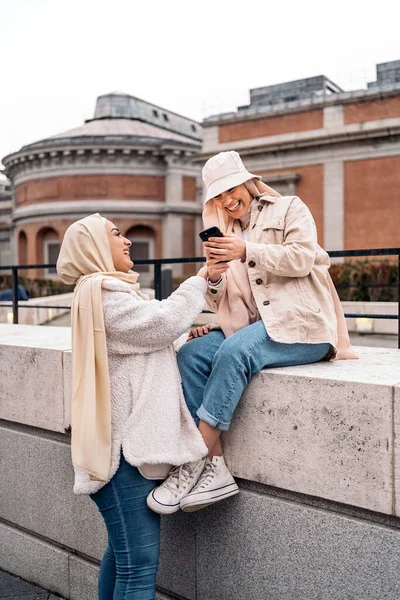 Cheerful Girls Wearing Hijab Having Fun Using Phone Street — ストック写真