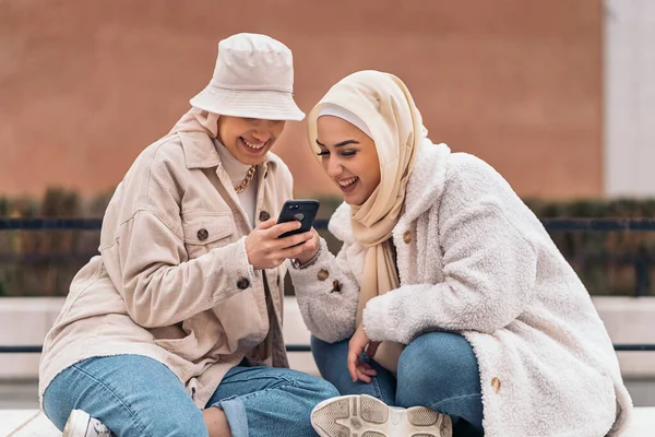 Cheerful Girls Wearing Hijab Having Fun Using Mobile Phone — ストック写真