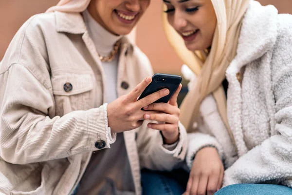 Cheerful Girls Wearing Hijab Having Fun Using Phone Street — ストック写真