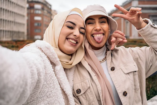 Cheerful Girls Wearing Hijab Having Fun Taking Selfie Street — Fotografia de Stock