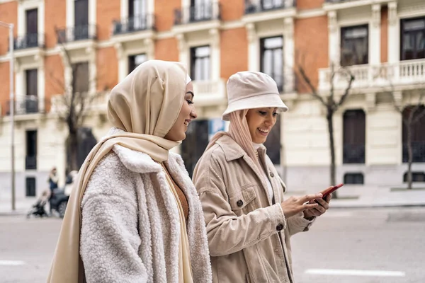 Cheerful Girls Wearing Hijab Having Fun Using Phone Street — ストック写真