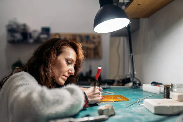 Concentrated Adult Woman Working Jewelry Workshop — стоковое фото