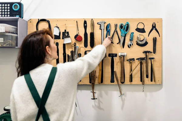 Craftswoman Selecting Tool Working Jewelry Workshop — Fotografia de Stock