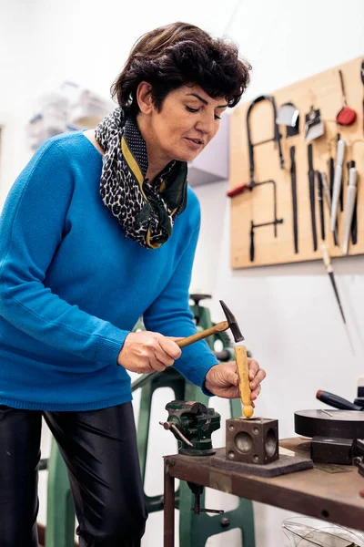 Concentrated Adult Woman Using Hammer Jewelry Workshop — Photo