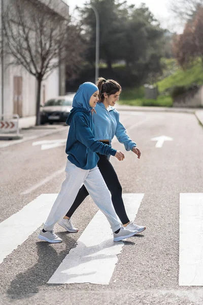 Cheerful Active Girls Wearing Sports Clothes Walking Crossing Street Zebra — Foto de Stock