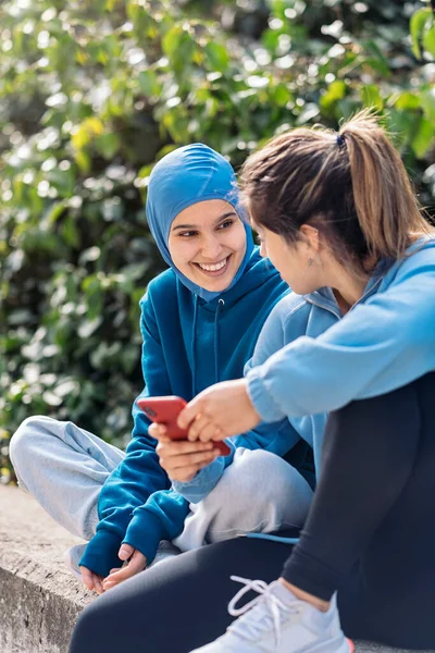 Happy Young Muslim Girl Sitting Her Friend Street Talking Using — ストック写真
