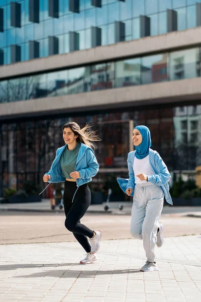 Cheerful Muslim Woman Wearing Hijab Running Street Her Friend Having — ストック写真