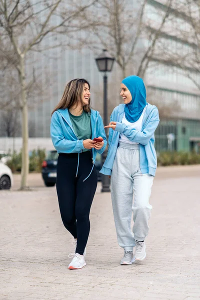 Active Muslim Girl Her Friend Walking Street Using Mobile Phone — ストック写真
