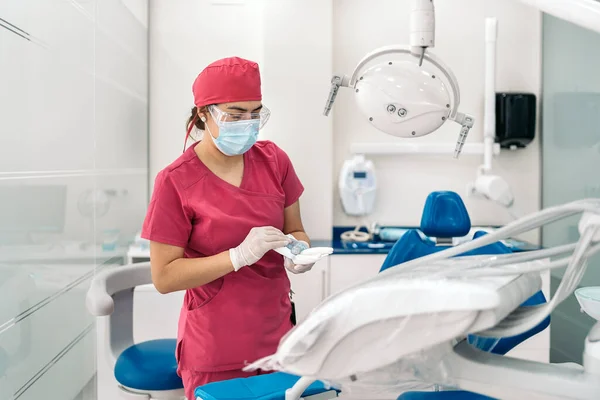 Female Dentist Working Modern Dental Clinic Wearing Face Mask She — стоковое фото
