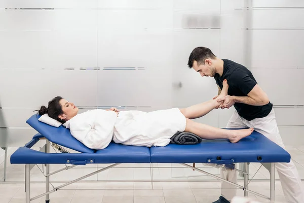 Relaxed Woman Lying Stretcher Receiving Body Massage — стоковое фото