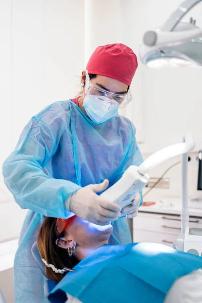 Woman Lying Dental Chair Wearing Protective Glasses Using Tooth Whitening — 스톡 사진