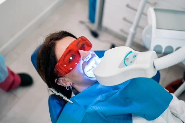 Woman Lying Dental Chair Wearing Protective Glasses Using Tooth Whitening — 스톡 사진