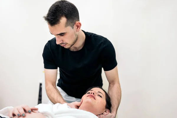 Male Physiotherapist Giving Neck Massage Relaxed Woman Lying Stretcher — 图库照片