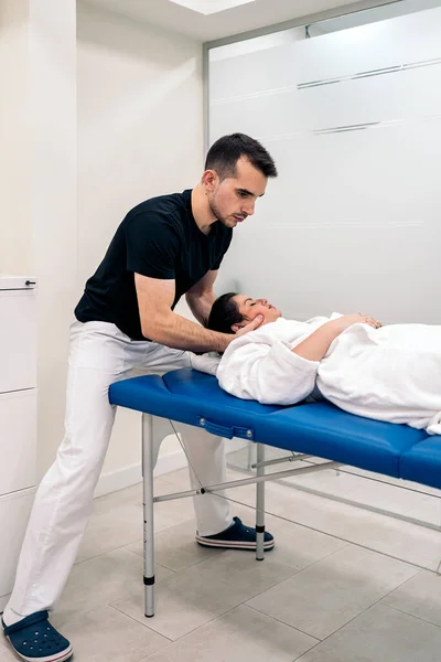Male Physiotherapist Giving Neck Massage Relaxed Woman Lying Stretcher — Φωτογραφία Αρχείου