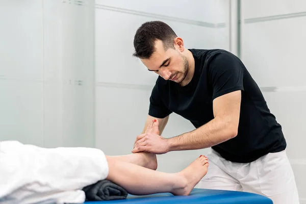 Male Physiotherapist Giving Feet Massage Unrecognized Woman Lying Stretcher — Φωτογραφία Αρχείου