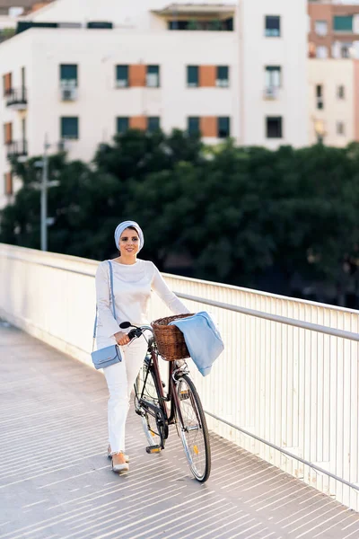 Vertical Image Muslim Woman Walking Her Bicycle Sidewalk Looking Away Stock Image