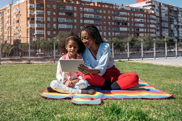 Afrikanerin Sitzt Mit Ihrer Kleinen Tochter Gras Und Nimmt Tabletten — Stockfoto
