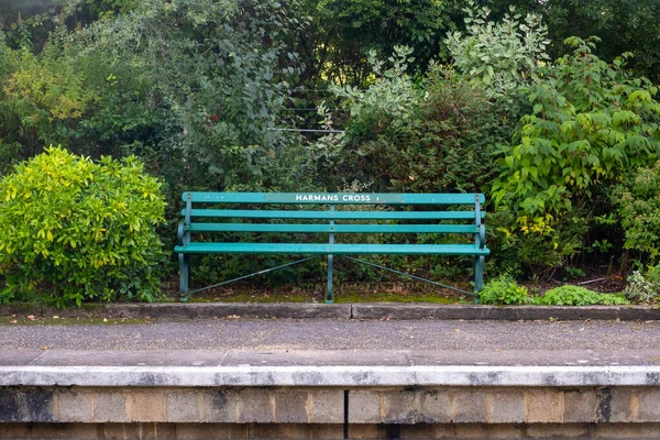 green bench on a train station