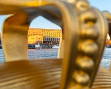 Stockholm, Sweden - October 19, 2021: Look through the frame of golden crown on the bridge