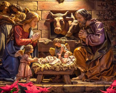 Colmar, France - December 28, 2021: An isolated nativity scene with Jesus in the manger in Cathedral in Colmar, France, before the Christmas period, with different figurines in the scene
