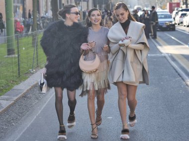 Fashion blogger Karina Nigai, Mary Leest and Kasia walking in the street after Fendi fashion show during Milano fashion week woman fall/winter collections