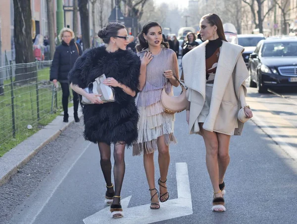 Fashion blogger Karina Nigai, Mary Leest and Kasia walking in the street after Fendi fashion show during Milano fashion week woman fall/winter collections