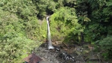 gurgling clear waterfall flow in the cool mountains of Indonesia. This waterfall flow is a source of water and beautiful tourism.