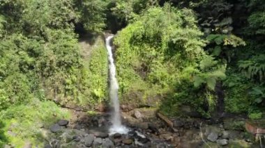 gurgling clear waterfall flow in the cool mountains of Indonesia. This waterfall flow is a source of water and beautiful tourism.